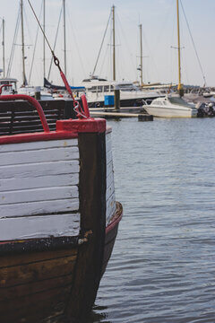 Fishing Boat Stern In Harbor With Sailboat Masts In Soft Background